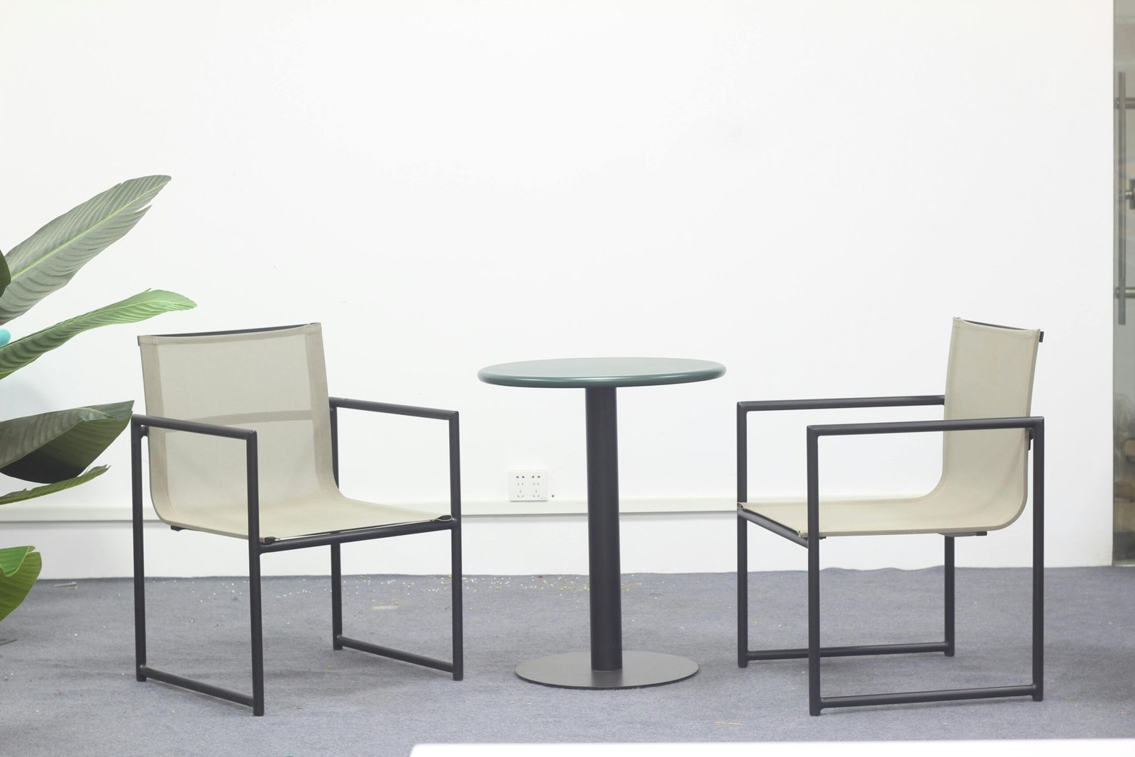 A minimalist office setup with two armchairs and a table, perfect for modern interiors.